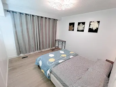 a bedroom with a bed and a large window at Private Room Near Airport D9 in Brampton