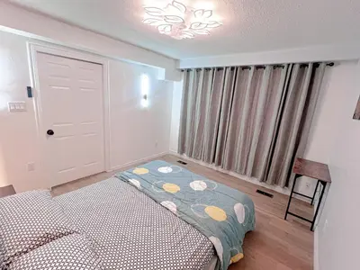 a small bedroom with a bed and a window at Private Room Near Airport D10 in Brampton