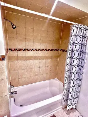a bathroom with a bath tub with a shower at Private Room Near Airport D10 in Brampton