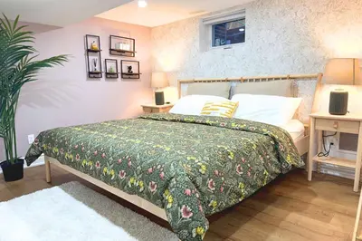 a bedroom with a bed with a green bedspread at Resort-like 4BR 3BA near Downtown, Four seasons Hot Tub, Gym, King Bed in Toronto