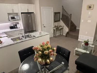 a kitchen with a table with a vase of flowers on it at A Compact family home in Milton in Milton