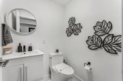 a bathroom with a toilet and butterflies on the wall at NEW Stylish 1BR Apartment With BBQ and Situated Close to the Falls and Can Sleep 4 Guests in Niagara Falls