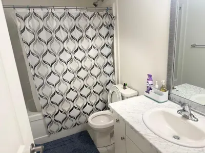 a bathroom with a toilet and a shower curtain at LuxSpace Properties in London