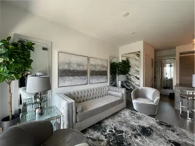 a living room with a couch and two chairs at Toronto Bloor & Yonge Luxury Condo in Toronto