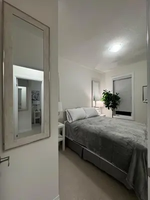 a bedroom with a large mirror and a bed at Ivylea Elegant Luxury Estate Richmond Hill in Richmond Hill
