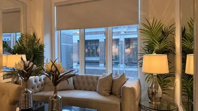 a living room with a couch in front of a window at Ivylea Elegant Luxury Estate Richmond Hill in Richmond Hill