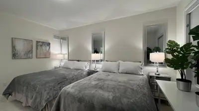 a bedroom with two beds and two lamps at Ivylea Elegant Luxury Estate Richmond Hill in Richmond Hill
