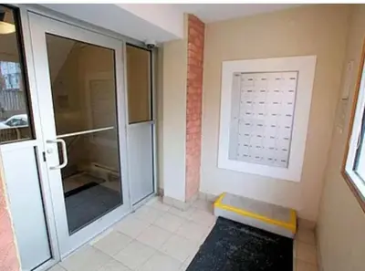 a bathroom with a walk in shower and a glass door at 56 Hiawatha in Woodstock