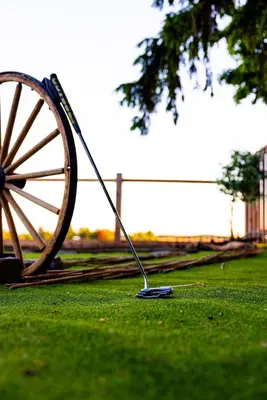 a wooden wagon wheel sitting in the grass at The White House in Caledonia