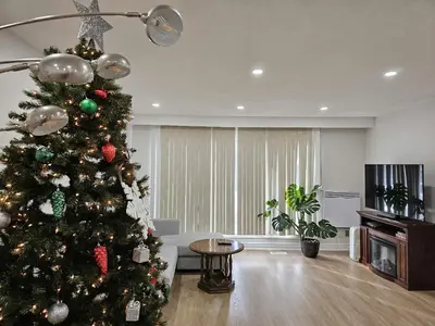 a christmas tree in a living room at A Home Away-Cozy Guest Room in Toronto in Toronto