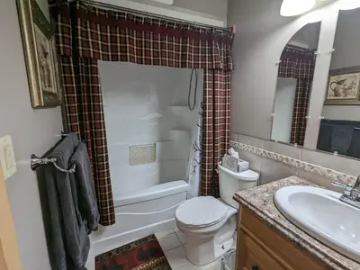 a bathroom with a toilet and a sink and a shower at Stone Ridge Chalet Bed n Breakfast in Dorset