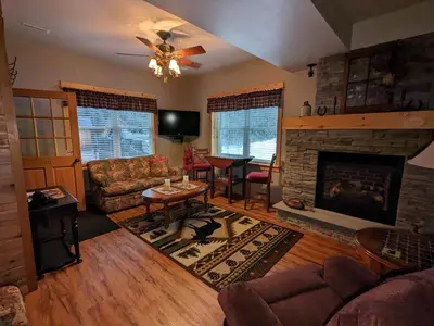 a living room with a couch and a fireplace at Stone Ridge Chalet Bed n Breakfast in Dorset