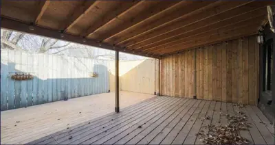 a large room with a wooden floor and a wooden ceiling at Casa Queen East - Modern 2BR Suite in Leslieville in Toronto
