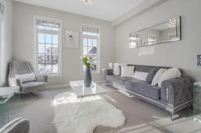 a living room with a couch and a table at The Bliss in Bowmanville