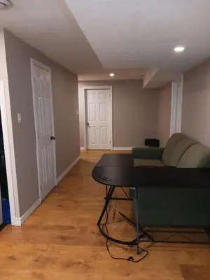 a living room with a couch and a table at CheapSleep Room Near Kitchener Airport- 24X7 Checkin in Kitchener