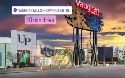 a sign in front of a shopping center at Cozy Walkout Suite in Vaughan