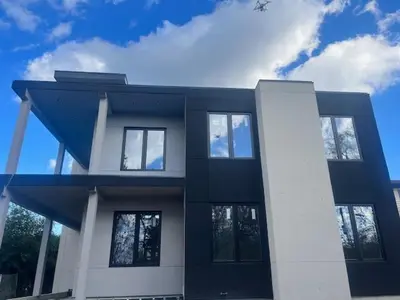 a black and white building with windows and a sky at The Lake House in Georgina