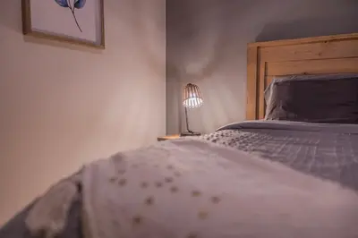 a bedroom with a bed and a lamp on a table at 6 Bedroom Modern Escape in Horseshoe, Pool and Hot tub in Coldwater