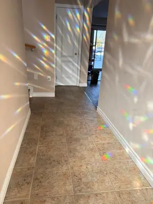 an empty hallway with a tile floor and white walls at 2 beds suit in Kitchener