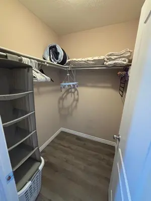 a walk in closet with shelves and a hallway at 2 beds suit in Kitchener