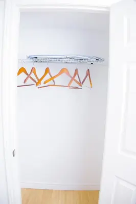 a shelf in a white room with shoes on it at Cozy relaxation haven 1 Bedroom basement in London
