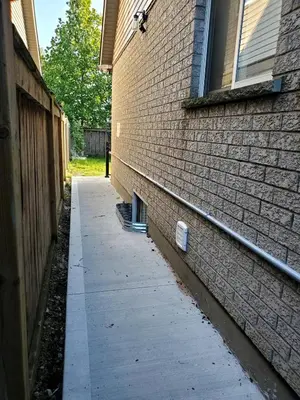 a side walk next to a brick building at Cozy relaxation haven 1 Bedroom basement in London