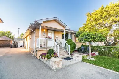 a house with a staircase in front of it at Entire Basement Apartment in Toronto