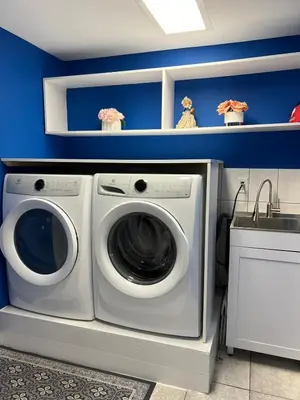 a laundry room with a washing machine and a sink at Entire Basement Apartment in Toronto