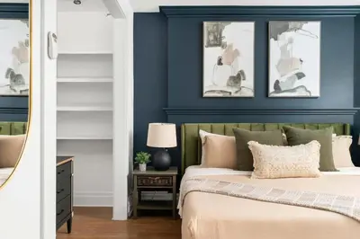 a bedroom with blue walls and a bed with pillows at 1BR Apartment Near Queen West in Toronto