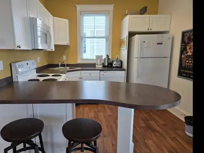 a kitchen with a counter top and a refrigerator at The Monarch - 4 Butternut in Cherry Valley