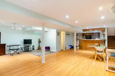 a large living room with a table and a kitchen at Large Guest suite with bathroom, vegetarian kitchen in Mississauga