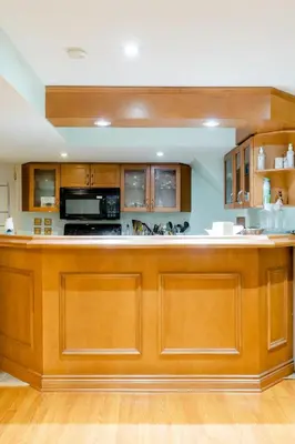 a large kitchen with wooden cabinets and a counter top at Large Guest suite with bathroom, vegetarian kitchen in Mississauga