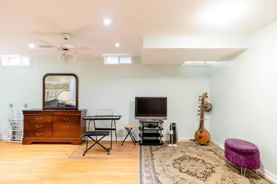 a living room with a tv and a mirror at Large Guest suite with bathroom, vegetarian kitchen in Mississauga