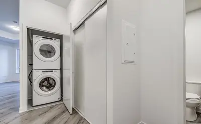 a laundry room with a washer and dryer next to a toilet at Stunning new condo in Oakville in Oakville