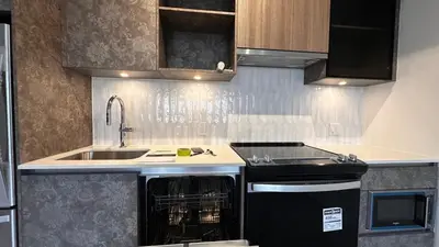 a kitchen with a sink and a dishwasher at Stunning new condo in Oakville in Oakville