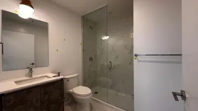 a bathroom with a shower and a toilet and a sink at Stunning new condo in Oakville in Oakville