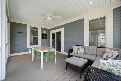 a patio with a couch and a table on a porch at The Hemlock - 1 Hollow in Cherry Valley