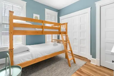 a bunk bed in a room with blue walls at The Hemlock - 1 Hollow in Cherry Valley