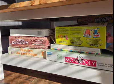 a stack of books sitting on a shelf at The Trillium - 2 Pine Forest in Cherry Valley