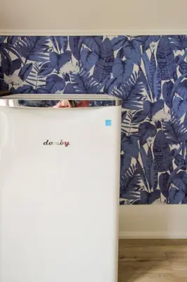 a white refrigerator with a bed in a room at Guest Suite w Ensuite Waterfront in Belleville