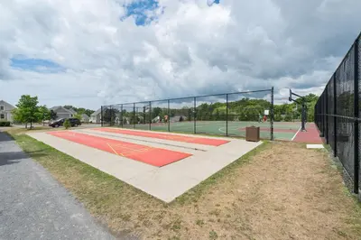 a tennis court with a net on a court at The Phoebe - 65 Butternut in Cherry Valley