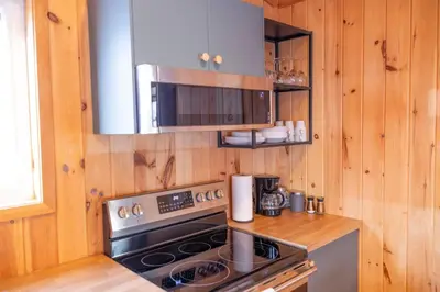 a kitchen with a stove and a microwave at Lake View Loft in Severn