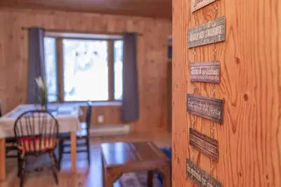 a room with a wooden wall with signs on it at Lake View Loft in Severn
