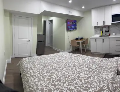 a bedroom with a large bed and a kitchen at B3 Luxury home in Mississauga nearby shipping center square one in Mississauga
