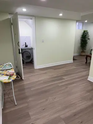 an empty room with a large white wall and wooden floors at B3 Luxury home in Mississauga nearby shipping center square one in Mississauga