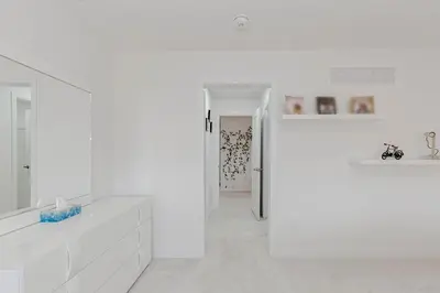 a white bathroom with a sink and a mirror at Amazing Home in Niagra Region in Thorold