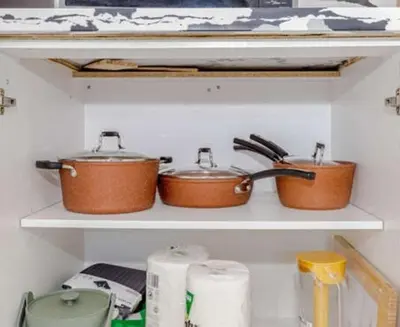 three pots and pans on a shelf in a kitchen at Amazing Home in Niagra Region in Thorold