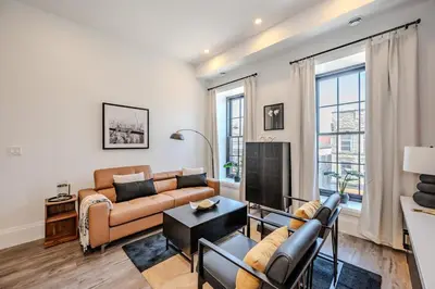 a living room with a couch and a table at Charming 2 Bed Apartment in Cambridge