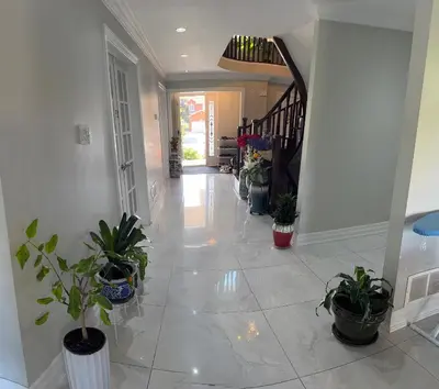 a hallway with potted plants in a house at F3 Spacious room with 2 queen beds and TV in Mississauga