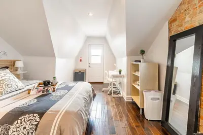 a bedroom with a large bed and a desk at Modern City Suite with Rooftop Patios in Toronto